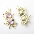 Detailansicht von Flüssigmetall-Herzanhängern mit rosa Kristallen und Diamanten - Gold Rosa Strass
