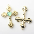Detail of gold-plated alloy cross pendant with rose wrap and green heart stone - Green Gold