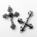 Macro detail of vintage silver cross charm with rose vine and heart-shaped black stone - Black Graphite