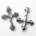 Detailed macro of vintage silver cross charms with rose motifs and cat-eye heart stones - Gray Graphite