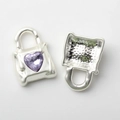 Macro view of silver handbag pendant featuring a purple heart-shaped rhinestone detail - Purple Zirconia