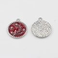 Detail view of round red enamel flower pendant with rhinestones and hammered metal back - Red & Silver