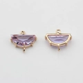 Macro shot of semi-circle light purple crystal pendants with gold-plated metal frames - Purple