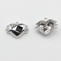 Macro view showing both sides of a heart charm with black and star stones - Black-Silver