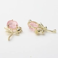 Detailed view of two gold alloy rose flower charms with pink petals for DIY jewelry making - Pink-Gold 01