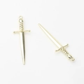 Macro detail of polished gold-plated alloy long sword pendants for DIY jewelry making - Gold