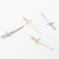 Close-up of gold and silver long sword pendants with decorative hilts for DIY jewelry - Random Mix