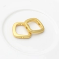 Close-up of golden square matte beads with side holes for DIY jewelry making - Matte Gold