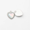 Macro detail of heart charm showing silver beaded edges and iridescent zircon inlay - Silver-Blue