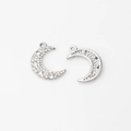 Close-up of silver crescent moon charms with white zircon inlay for DIY jewelry making - Silver