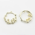 Detailed view of lily of the valley flower charm in golden circular wreath design - Gold Plating