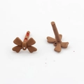 Detailed view of matte brown bowknot stud earrings showing material and texture - Brown