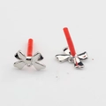 Close-up of silver bow jewelry pendants with small rings and red protective needle caps - Silver