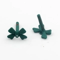 Detailed macro view of dark green matte bow charms for DIY jewelry and crafts making - Green