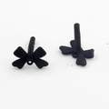 Detailed view of matte black bow-shaped earring posts with connector loops for jewelry making - Black