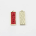 Detailed macro view of Chinese lucky gold-plated alloy charms with red embossed text - Red-Bringing Wealth