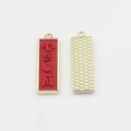 Macro view of red alloy charm with embossed Chinese characters and gold-tone finish - Red-Wish Fulfillment