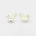 Detailed view of rabbit ear pearl charms for jewelry making in white enamel finish - White