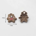 Detail view of cute resin bear charms with pink cheeks, white pearls, and red hearts - Brown Heart Rabbit