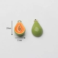 Detail view of papaya alloy pendants with orange enamel and gold trim, 20mm x 11mm size - Papaya