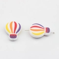 Detail of colorful hot air balloon silicone beads showing horizontal threading hole - Warm Tone