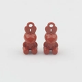 Macro shot of a pair of cute rabbit-shaped alloy pendants with deep red oil dripping finish - Orange