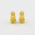 Close-up of two yellow enamel 3D rabbit charms for DIY jewelry making accessories - Yellow