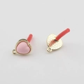 Detailed close-up of pink enamel heart charms with gold edges and textured metal backing - Pink