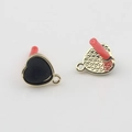 Macro shot of heart-shaped black enamel earrings with gold plating and DIY loop - Black