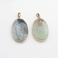 Close-up of vintage oval agate stone pendants with gold metal edges for DIY necklaces - Long Pendant Style
