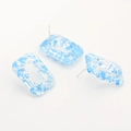 Detail of rectangular resin earrings with blue splatter pattern and silver metal studs - Blue