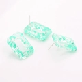 Detailed macro view of S925 silver needles on floral resin geometric earrings - Green