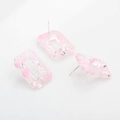 Detail view of rectangular resin stud earrings with pink ink splatter and metal pins - Pink