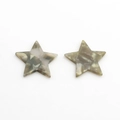 Macro shot of two star-shaped acetate charms with marble grey and white textures - Green