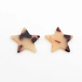 Macro view of amber star-shaped resin charms with tortoiseshell patterns for DIY jewelry - Milk Tea