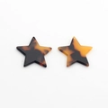 Macro detail of amber star charms made of acetate resin with tortoiseshell texture for DIY - Amber