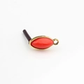 Macro detail of red marquise resin earring with gold metal frame and small hanging loop - Orange