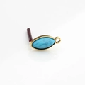 Detail of vintage golden alloy turquoise resin charm with oval horse-eye shape - Blue Sodalite