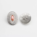 Detailed view of vintage silver alloy shank button with oval red resin stone inlay - Orange