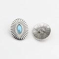 Macro detail of vintage silver oval button with blue marquise stone and sunburst texture - Sky Blue