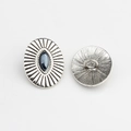 Macro detail of antique silver oval buttons with navette dark stone inlay and ray texture - Smoke