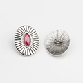 Macro view of vintage silver alloy oval buttons with red marquise stone and relief texture - Rose Red