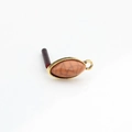 Detailed close-up of retro golden alloy marquise resin earring stud with amber texture - Orange Textured