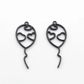 Detailed macro view of two black balloon charms with hollow heart patterns for DIY crafts - Black