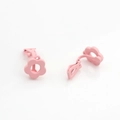 Detailed close-up of matte pink flower-shaped clip-on earring with central cutout - Pink