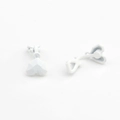 Macro detail of white matte heart-shaped earring accessories with geometric 3D facets - White