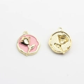 Detail of double-sided rose charm with pink enamel inlay and gold plated metal finish - Pink-Gold