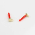 Macro detail of red cylindrical DIY earring pendants with gold metal ring connectors - Gold