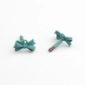 Detail of matte teal alloy bow charms showing the spray-painted finish and hanging loops - Turquoise Green