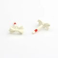 Macro detail of cream white mini bow charms for DIY earring and jewelry making - White